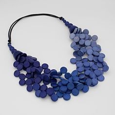 "Five elegant strands of ombre-style wooden beads in shades of blue.  This adjustable statement necklace can fill in a neckline or can be worn longer to complete your look. Fully adjusts on a black wax cord from 18\" to 26\" long  Adjustable length: 22\" to 32\"  Beads are ½\" in diameter  Care Instructions: Remove jewelry when applying perfumes, creams, washing hands etc. Do not store in direct sunlight. To restore color and shine apply a drop of oil with a soft cloth." Blue Multi-strand Wooden Bead Necklaces, Ombre Necklace, Hand Knotted Necklace, Rainbow Necklace, Multi Layer Necklace, Party Necklace, Bird Jewelry, Teardrop Necklace, Necklace Statement