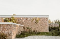 an outdoor courtyard with brick walls and trees