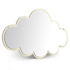 a white cloud shaped mirror sitting on top of a table