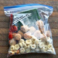 a bag filled with macaroni and cheese on top of a wooden table