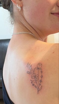 a woman with a flower tattoo on her shoulder