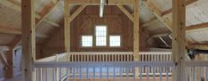 an empty loft with wooden walls and beams