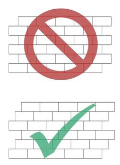 there are two different signs on the brick wall, one is not allowed to enter