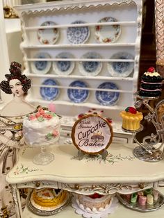 an assortment of cakes and cupcakes on display