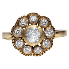 an antique diamond cluster ring in yellow gold