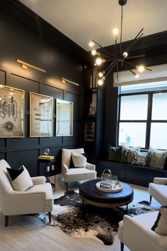 a living room with black walls and white furniture