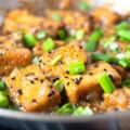 a pan filled with tofu and green onions