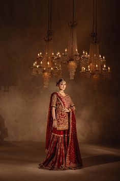 Red Pakistani Bridal Dress in Gharara and Kameez Style is embellished with Kiran, Mukaish, and Sitara work. Lavish designs and perfect stitching make this stunning Gharara Kameez an epitome of beauty and your foremost priority to have a head-turning magical look. Bridal Kameez: The kameez in an alluring red shade is beautifully embellished with goldwork and embroidery. Lavish details of Kiran, Mukaish, and Sitara make this stunning red kameez a perfect choice to wear on the most important day of your life. Half sleeves and intricate designs give a traditional touch to the kameez. Bridal Gharara: The Bridal Gharara is perfectly stitched and its borders are hand-embellished with gold embellishments and floral designs. The Gharara is in self-jamawar fabric. This Gharara can be customized to L Red Gharara Bridal, Red Engagement Dress, Red Pakistani Bridal Dress, Red Gharara, Pakistani Bridal Outfits, Dresses Pakistani Wedding, Garara Dress, Gharara Dress, Kameez Style