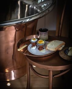 an assortment of food on a plate in front of a large copper pot and sink