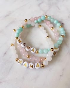 "These five unique \"Mama\" bracelets are made with a variety of gemstones and gold-filled spacer beads. Each piece is totally different and so elegant and beautiful to be worn out or even just day to day wear. This would make the perfect gift for Mother's Day or to add to your bracelet stack! If you would like to customize the \"mama\" part, that is totally fine. Please just message me letting me know what you prefer your bracelet to say. Also, check out my other listings to see how these brace Mothers Day Bracelet Ideas, Trendy Beaded Bracelets For Mother's Day, Mothers Day Bracelets Diy, Mommy Bracelets, Mother’s Day Bracelet Ideas, Mothers Day Bracelets, Mother’s Day Bracelet, Beaded Bracelet Stacks, Cute Personalized Beaded Bracelets For Mother's Day