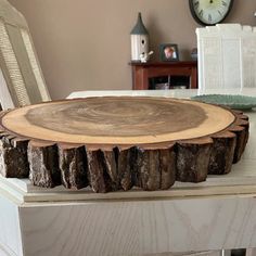 a wooden table with a clock on the wall behind it