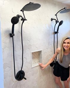 a woman standing next to a shower head