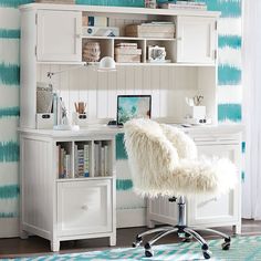 a white desk and chair in front of a wall with blue stripes on it's walls