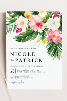 an elegant floral wedding card with white and pink flowers on the front, green leaves in the back