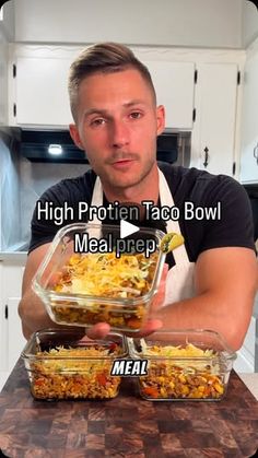 a man is holding two containers of food on a counter top with the words high protein taco bowl meal prepped in front of him