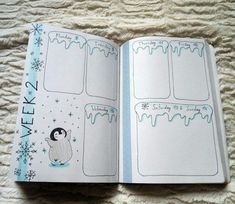 an open planner book on a bed with snowflakes and penguins in the pages