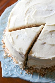 a cake with white frosting on a blue plate