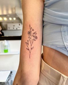 a woman with a flower tattoo on her arm