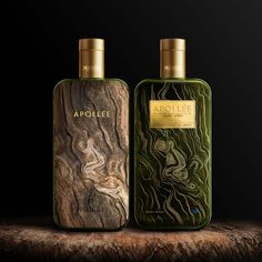 two bottles of cologne sitting on top of a wooden table