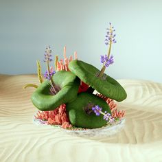 an arrangement of plants and flowers on a bed