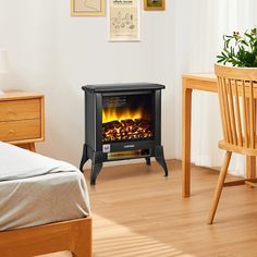 a small stove in the corner of a room next to a bed and table with a chair