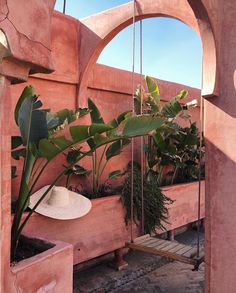 an outdoor area with potted plants and hanging planters