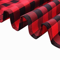 red and black checkered fabric is folded on top of each other to create an interesting pattern