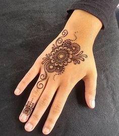 a henna tattoo on someone's hand