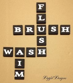 scrabble tiles spelling the words flush, brush, wash, i'm