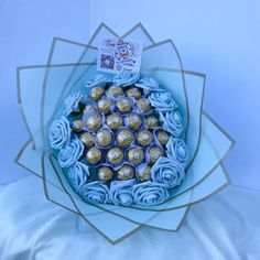 a bouquet of blue roses and chocolates in a paper wrapper