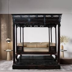 a canopy bed sitting in the middle of a living room next to a table and chairs