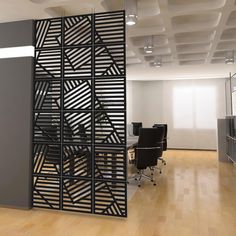 an office space with wooden floors and black partitions