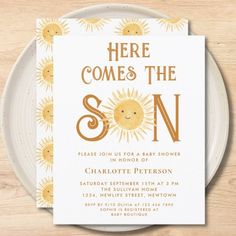 there is a white plate with a yellow sun on it and the words here comes the son