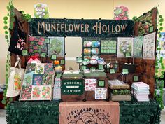 a table topped with lots of different types of greeting cards and flowers next to a sign that says mineflower hollow