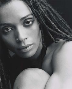 a black and white photo of a woman with dreadlocks