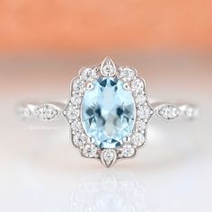 Gorgeous vintage inspired aquamarine ring is made of 925 solid sterling silver, making a simple but elegant statement piece. This ring is perfect to wear as engagement ring, promise ring, birthstone ring, or statement ring. Hypoallergenic, lightweight and minimalist.Main Stone: Aquamarine Shape: OvalGem size: 6 x 8 mmCarat Weight: 1.4 ct. (approx.)Stone Creation: Lab-CreatedHardness: 8 (Mohs scale)►Your sterling silver ring will not turn green itself and will not cause your skin to turn green.►V Vintage Aquamarine Ring, Aquamarine Ring Vintage, Gemstone Engagement Ring, Popular Engagement Rings, Engagement Ring For Women, Aquamarine Ring, Gemstone Engagement, Creating Jewelry, Wedding Ring Designs