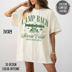 a woman wearing a t - shirt that says camp bach special club with trees and mountains on it