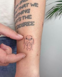 a person with a dog tattoo on their arm