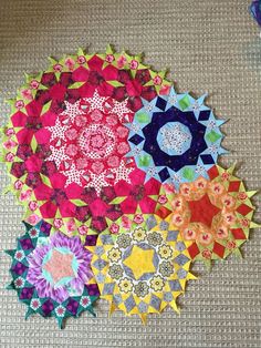 four circular quilts are arranged on the floor