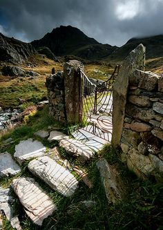 an old stone gate in the middle of nowhere