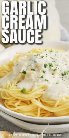 garlic cream sauce on top of pasta in a white bowl