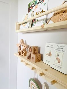 wooden toys and books are on the shelves in this child's playroom with white walls