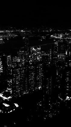 black and white photo of city lights at night from the top of a skyscraper building