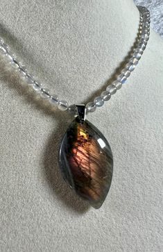 Beautiful labradorite pendant. Excellent orange, purple, and yellow flash pendant. Includes a custom made 20 inch labradorite beaded necklace. Amazing high quality crystal necklace.  Approximate pendant size: 1.5 inches x .9 inch  Approximate weight: 28 grams 6C PLEASE READ BELOW Each piece of crystal that we sell is individually selected from markets and wholesalers around the world. The crystal in the photo is the exact one that you will receive. We do not buy in bulk from factories and then create a listing with photos of the very best one and varying sizes, leaving you to hope that you might receive a nice one. Buy with the confidence of knowing what you will receive from us. Please let us know if you have any questions and we will be glad to help in any way possible. Thank you, Kelley Yellow Flash, Purple And Yellow, Labradorite Beads, Labradorite Pendant, Crystal Necklace, Favorite Jewelry, Labradorite, Jewelry Necklace Pendant, Violet