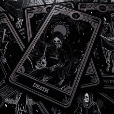 some black and gold playing cards with skeletons on them