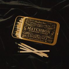 matchbox matches are sitting on a black cloth