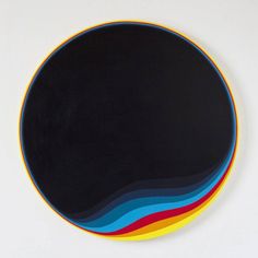 a black plate with multicolored lines on it