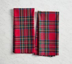 two red plaid napkins sitting on top of a white counter