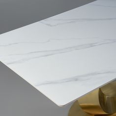 a white marble table top with gold accents