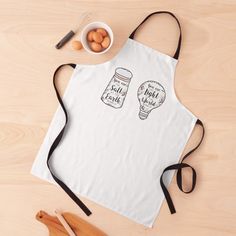 an apron with two jars on it and some eggs in the bowl next to it